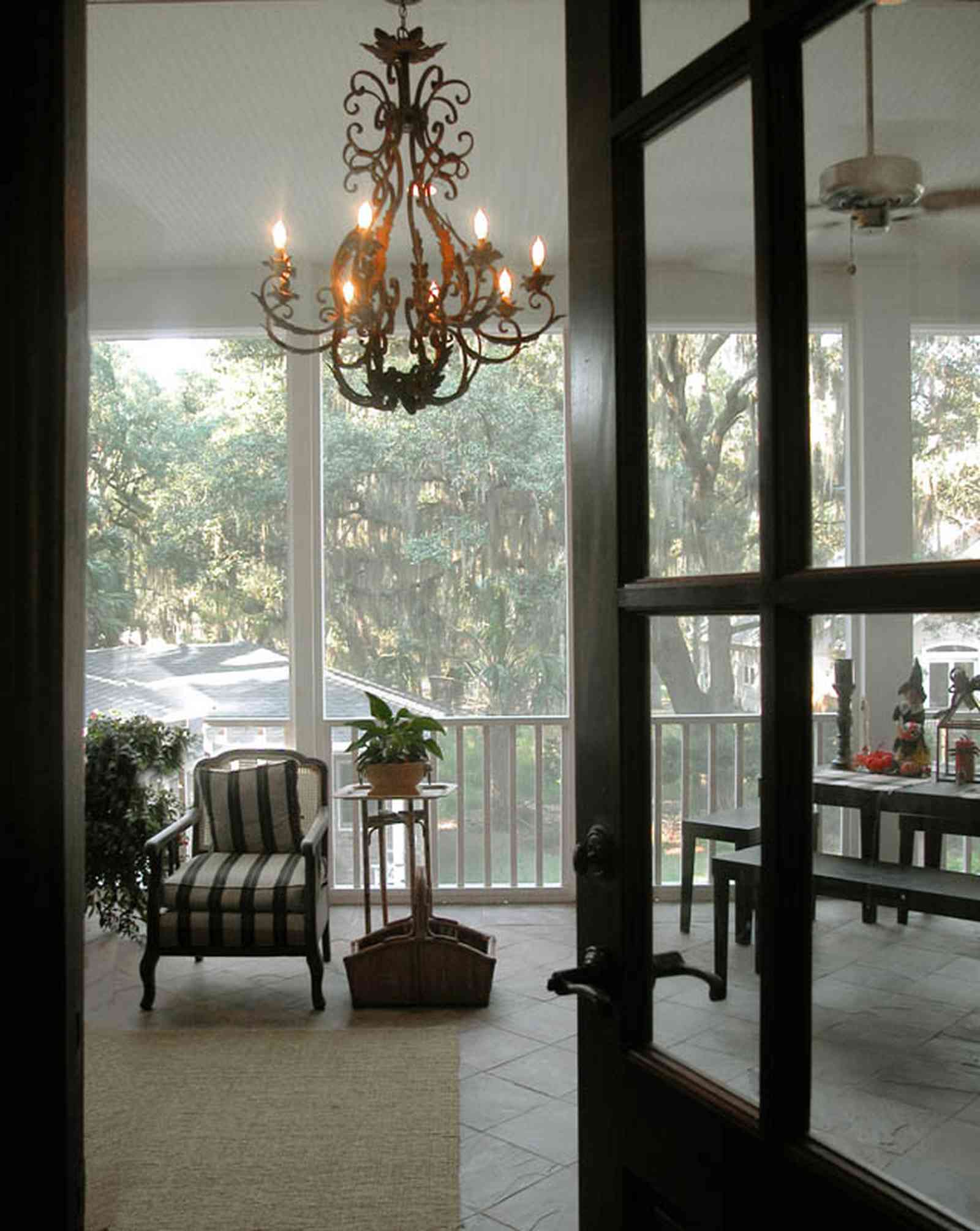 East-Pensacola-Heights:-112-Chipley-Avenue_09.jpg:  chandelier, slate floor, ceiling fan, screen porch, raised cottage