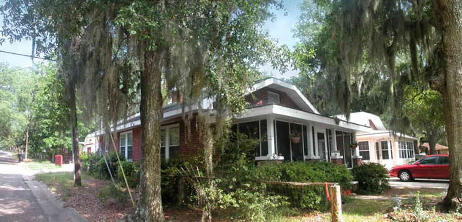 East-Pensacola-Heights:-118-Bayou-Blvd_03.jpg:  craftsman cottage, spanish moss, bayou texar, oak tree, red brick house