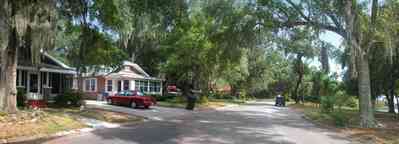 East-Pensacola-Heights:-118-Bayou-Blvd_05.jpg:  craftsman cottage, spanish moss, bayou texar, oak tree, red brick house