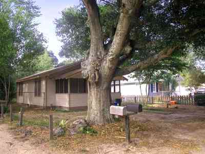 East-Pensacola-Heights:-3008-Strong-Street_06.jpg:  cottage, picket fence, ornamentation, oak tree, bannister, shutters