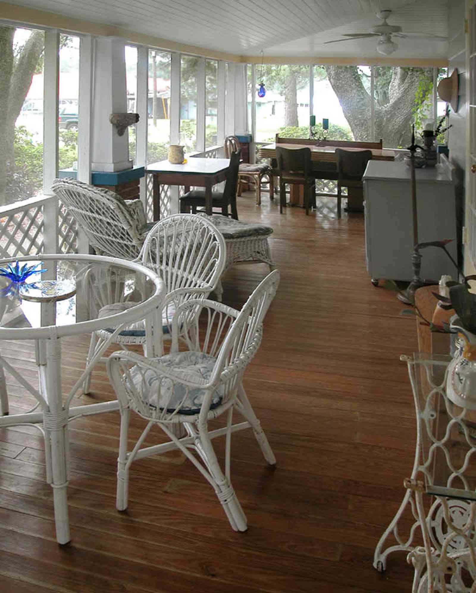 East-Pensacola-Heights:-600-Bayou-Blvd_22.jpg:  wooden floors, wicker porch furniture, screen porch, wide overhang, oak trees