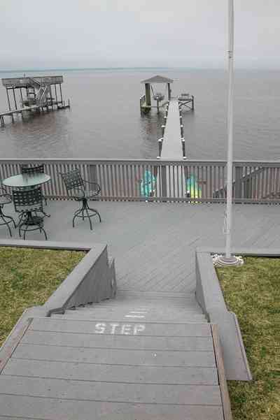 Gulf-Breeze:-228-North-Cliff-Dr_05.jpg:  swimming pool, bay, dock, pier, deck, flag pole, boat, bayfront