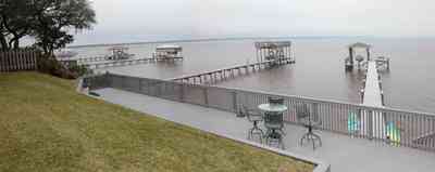 Gulf-Breeze:-228-North-Cliff-Dr_08.jpg:  swimming pool, bay, dock, pier, deck, flag pole, boat, bayfront