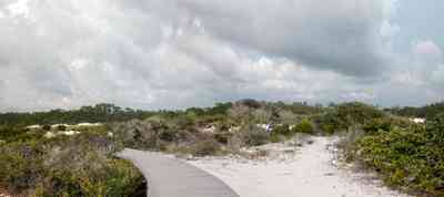 Gulf-Islands-National-Seashore:-Dunes-Nature-Trail_03.jpg:  boardwalk, dunes, storm, cumulus clouds, quartz sand, barrier island