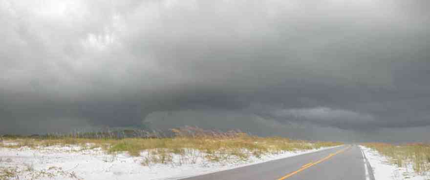 Gulf-Islands-National-Seashore:-Fort-Pickens-Road_01.jpg:  storm, dunes, sea oats, two-lane road, barrier island, cucumlus clouds, white sand