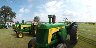 Jay:-Gabbert-Farm-Peanut-Festival_02.jpg:  tractor, john deere tractor, white fence, cows, farmland, pasture, festival, peanuts