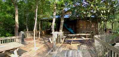Milton:-Adventures-Unlimited_06.jpg:  picnic table, deck, house, office, store
