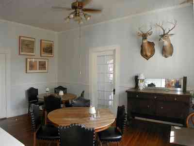 Milton:-Faircloth-Carroll-House-Restaurant_06.jpg:  picket fence, craftsman cottage, restaurant, shutters, ceiling fan, trophy heads, deer head, hunting lodge, french door, milton, front porch