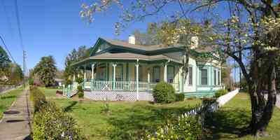 Milton:-Historic-District:-202-Berryhill-Street:-Chadwick-Hartsell-House_04.jpg:  white picket fence, dogwood tree, steamboat house, victorian house