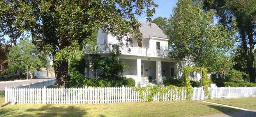 Milton:-Historic-District:-301-Pine-Street:-Butler-Potter-Schlenker-House_01.jpg:  victorian house, azalea bushes, picket fence, magnolia tree