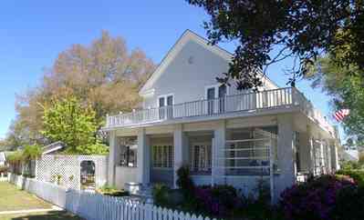 Milton:-Historic-District:-301-Pine-Street:-Butler-Potter-Schlenker-House_05.jpg:  wrap-around porch, arbor, azalea bushes, victorian home
