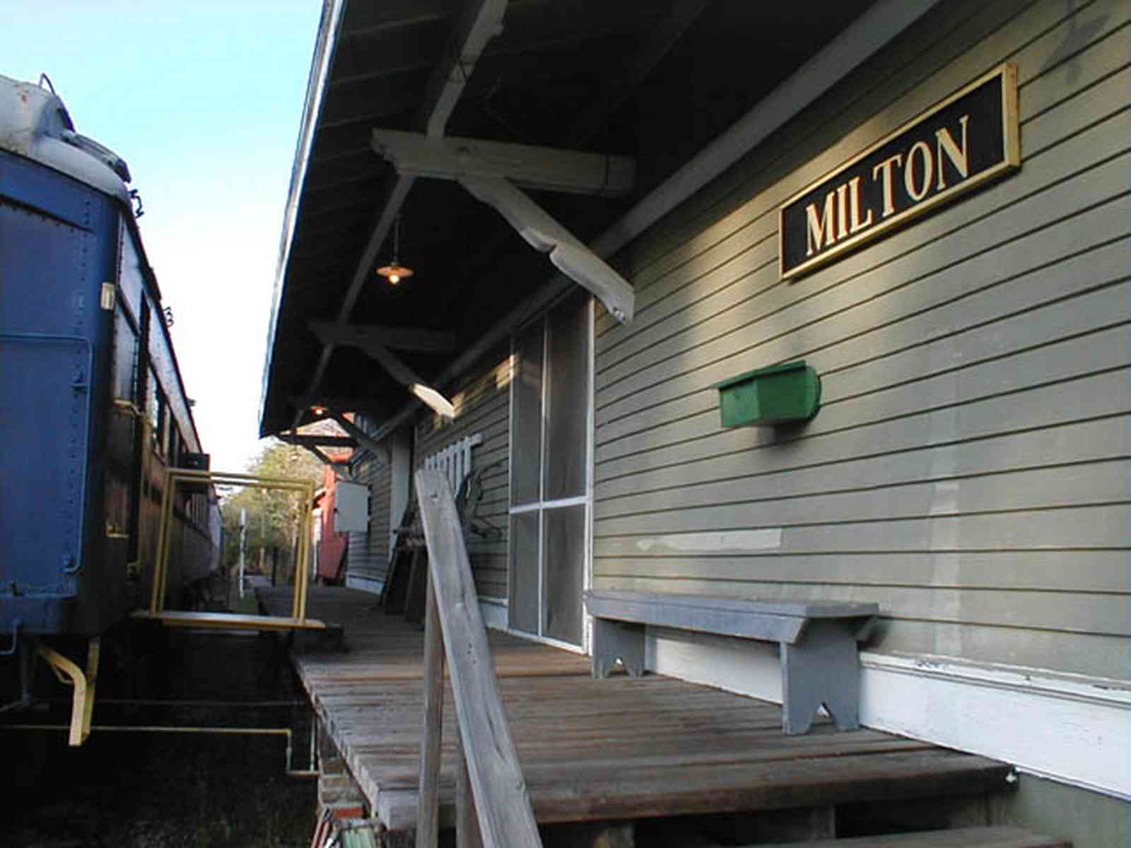 Milton:-L-N-Train-Depot_04.jpg:  train station, csx rail line, bench, dining car, caboose, train crossing