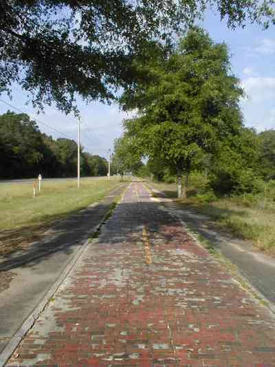 Milton:-Red-Brick-Road_13.jpg:  brick road, historic marker, highway, two-lane road, red brick