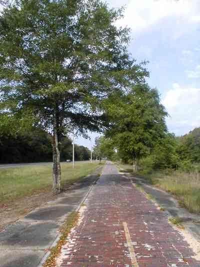Milton:-Red-Brick-Road_14.jpg:  brick road, historic marker, highway, two-lane road, red brick