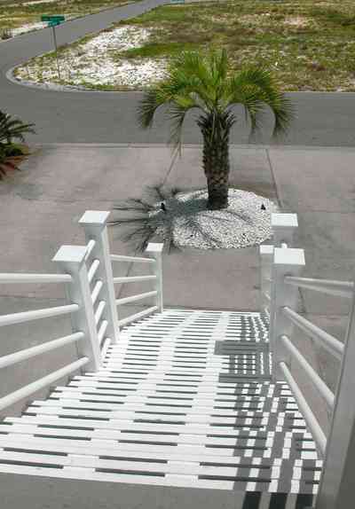 Navarre:-7332-Grand-Navarre-Blvd_01b.jpg:  front stairs, palm tree, driveway, beach house