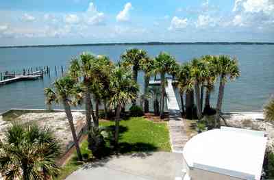 Navarre:-7332-Grand-Navarre-Blvd_08b.jpg:  palm trees, cabana bar, dock, pier, boat house, santa rosa island, santa rosa sound