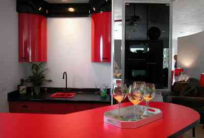 Navarre:-7332-Grand-Navarre-Blvd_27.jpg:  red lacquered cabinets, black laquered cabinets, art deco house, bar, kitsch, mirrored wall, bar glasses