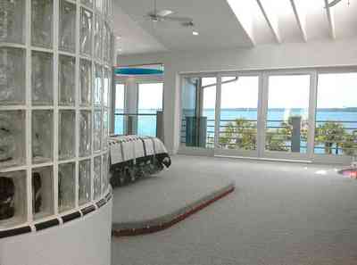 Navarre:-7332-Grand-Navarre-Blvd_52.jpg:  glass brick wall, bedroom, 3rd floor overlook, gulf view, palm trees, art deco deco, santa rosa sound