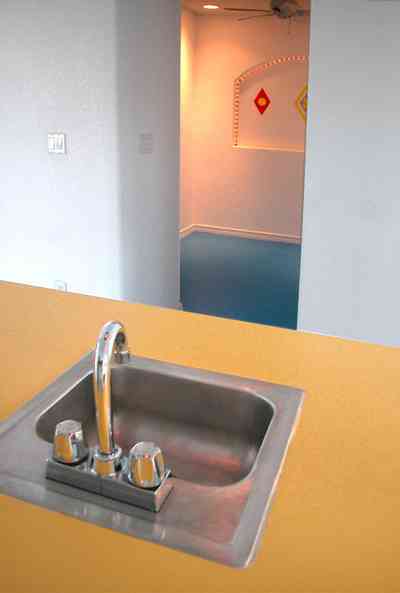 Navarre:-7332-Grand-Navarre-Blvd_64.jpg:  bar sink, yellow counter, blue floor, art deco design, art deco house