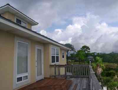 Navarre:-Biscayne-Pointe-Drive-House_16.jpg:  cumulus clouds, house, deck, marsh, wetland, palm tree