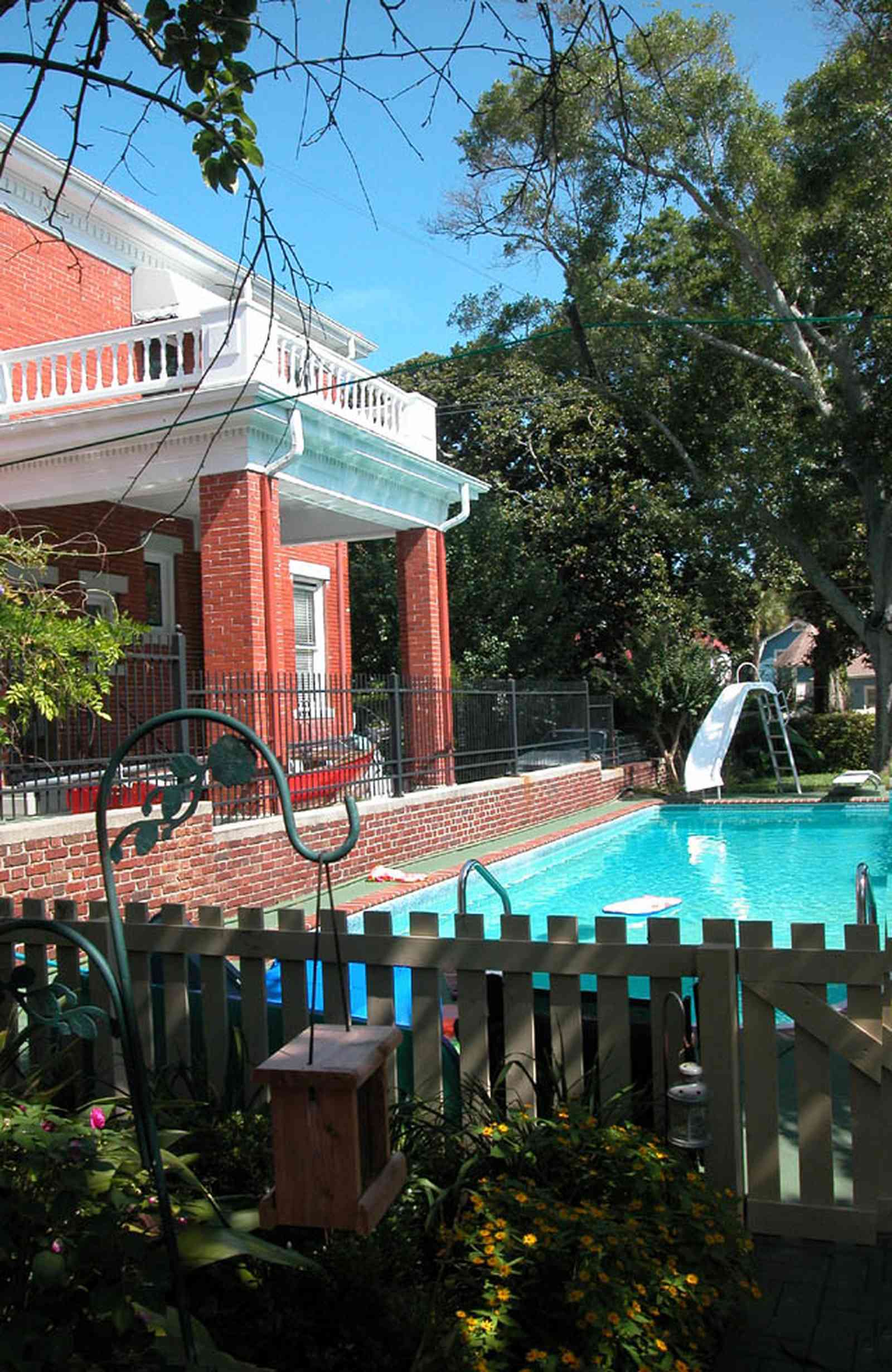 North-Hill:-105-West-Gonzales-Street_21.jpg:  swimming pool, slide, picket fence, bird house, wrought iron fence