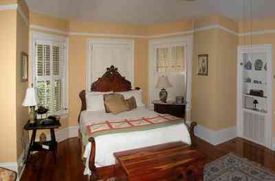 North-Hill:-105-West-Gonzales-Street_62.jpg:  antique bed, cedar chest, oriental rug, shutters, awnings wainscotting, hardwood floor