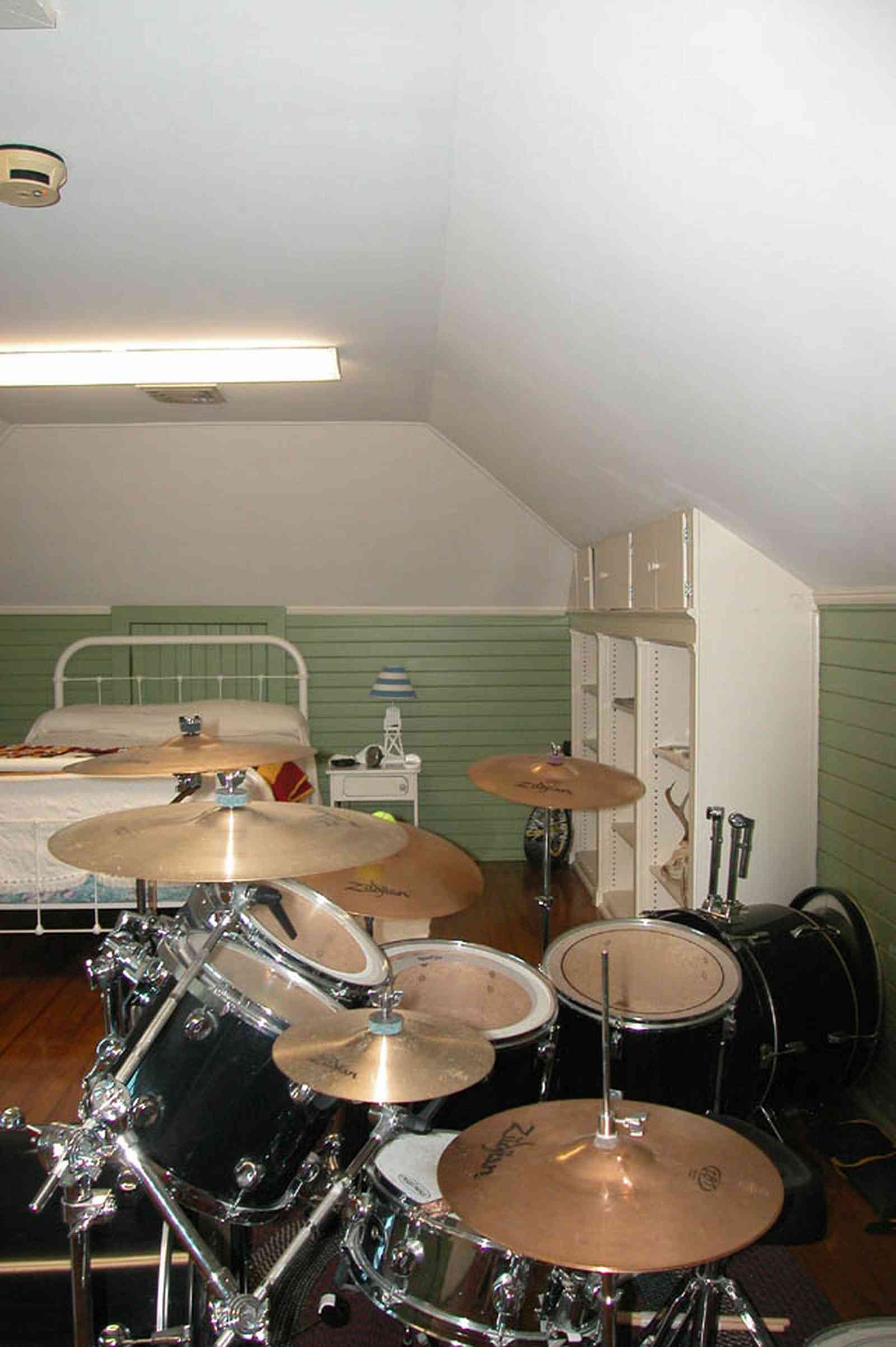 North-Hill:-105-West-Gonzales-Street_66.jpg:  attic bedroom, hooked rug, drum set, dormer room, hardwood floor