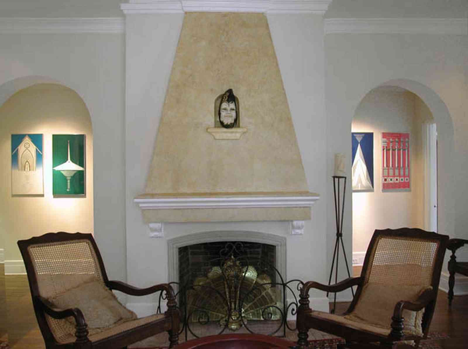 North-Hill:-123-West-Lloyd-Street_06.jpg:  fireplace, archway, arcade, stucco walls, cane backed chairs