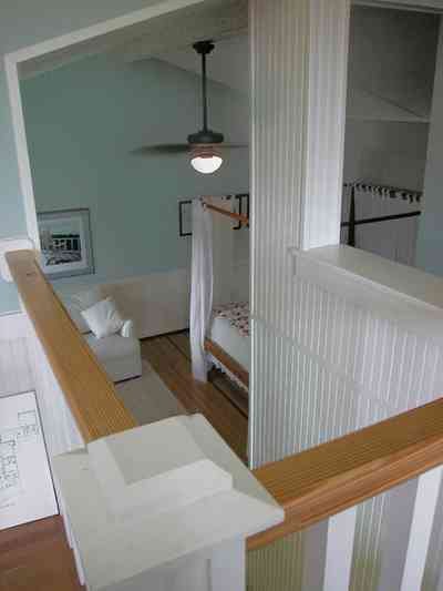 North-Hill:-284-West-Gonzales-Street_27c.jpg:  canopy bed, staircase, downstairs, garage apartment, sofa, ceiling fan, wainscotting
