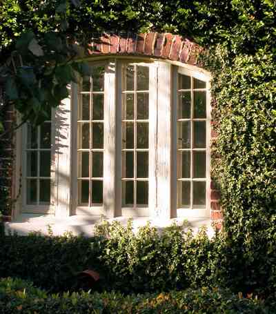 North-Hill:-406-Lloyd-Street_02.jpg:  casement window, ivy-covered walls, windowpane, castle, gothic revival, tudor architectural style