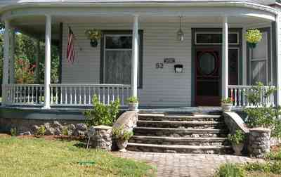 North-Hill:-52-West-Gonzalez-Street_03.jpg:  victorian home, front porch, pediment, stone staircase, casement windows, garage, queen anne architectural style