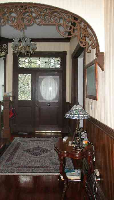 North-Hill:-52-West-Gonzalez-Street_06.jpg:  oriental rug, carved arch, tiffany lamp, beaded wall board, wooden floors, victorian home
