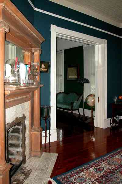 North-Hill:-52-West-Gonzalez-Street_11.jpg:  fireplace, mantel, oriental rug, dining room, victorian home, world globe, settee