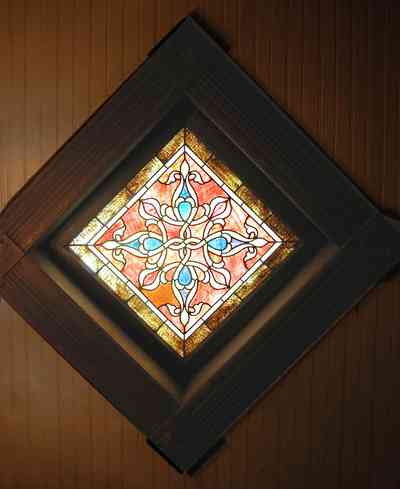 North-Hill:-52-West-Gonzalez-Street_18.jpg:  wooden walls, beaded panels, stained glass window, victorian house
