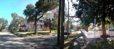 North-Hill:-620-North-Barcelona-Street_05.jpg:  magnolia tree, palm trees, victorian home, picket fence, two-lane street, victorian neighborhood, front porch