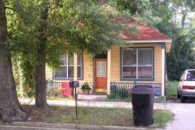Old-East-Hill:-415-La-Rua-Street_04.jpg:  craftsman cottage, brick street, driveway, oak trees, front porch, chain link fence