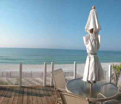 Pensacola-Beach:-Ariola-Drive-Art-Deco-House_08.jpg:  sand, crystal sand, porch, glass railing, deck, white sand, sugar sand, sea oats, bauhaus architectural style, palm trees, dune restoration, umbrella, deck, porch, glass railing, beachfront property