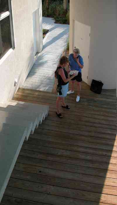 Pensacola-Beach:-Ariola-Drive-Art-Deco-House_10.jpg:  sand, crystal sand, white sand, sugar sand, sea oats, bauhaus architectural style, palm trees, dune restoration, stairs, glass railing, wooden deck, beachfront property