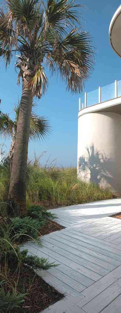 Pensacola-Beach:-Ariola-Drive-Art-Deco-House_10a.jpg:  sand, crystal sand, white sand, sugar sand, sea oats, bauhaus architectural style, palm trees, dune restoration, stairs, glass railing, wooden deck, beachfront property