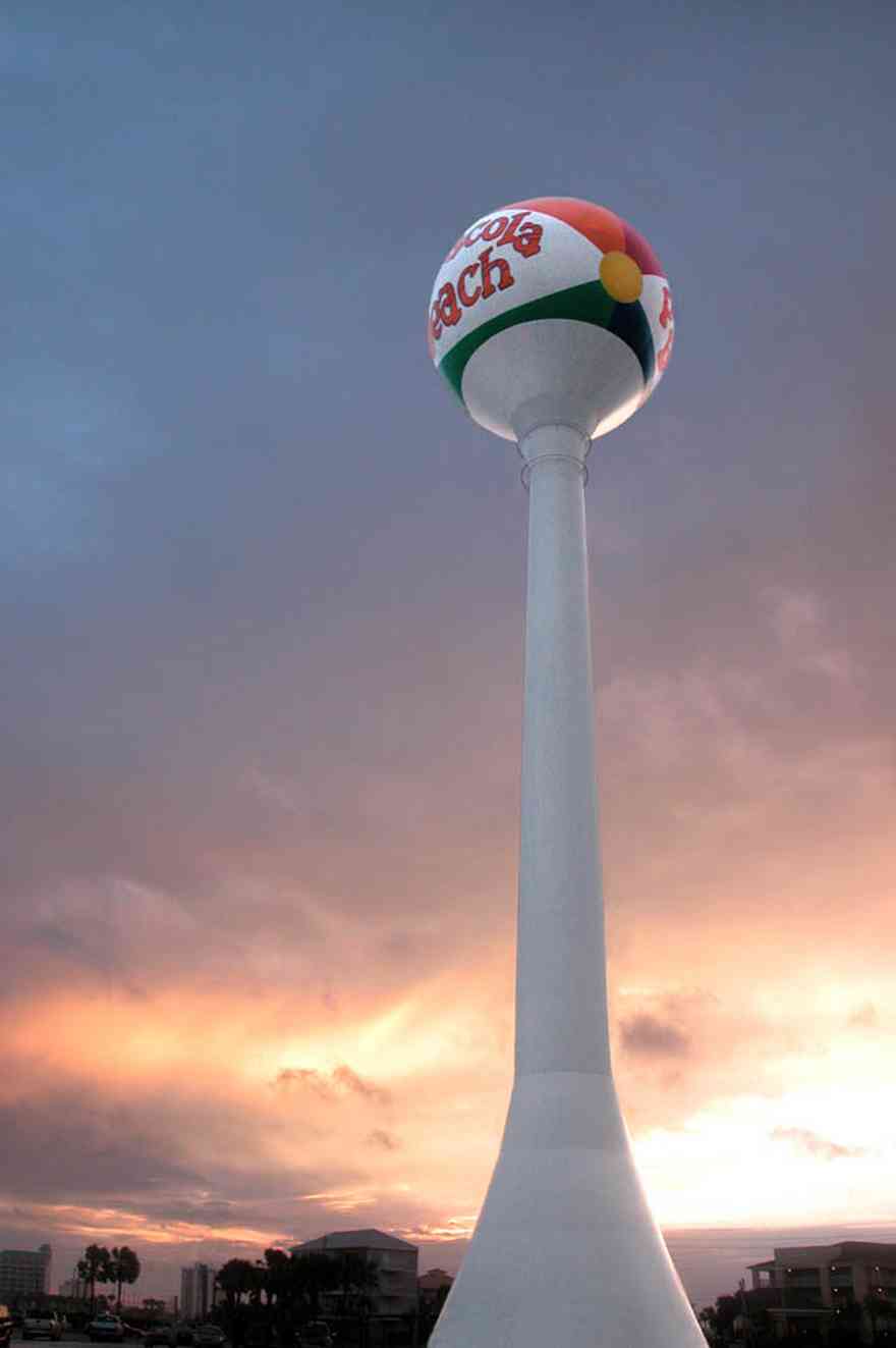 Pensacola-Beach:-Beach-Ball_01.jpg:  beach ball, water tower, tropical storm, mixed skies, palm trees, casino beach, parking lot, 