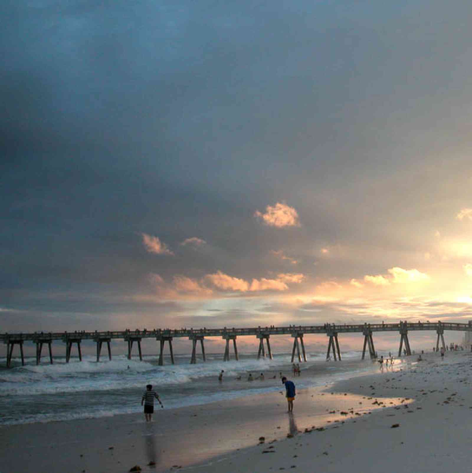 Pensacola-Beach:-Gulf-Fishing-Pier_02.jpg:  sunset, clouds, surf, surfers, sand, gulf of mexico