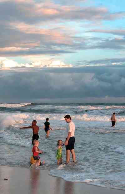 Pensacola-Beach:-Sunset_01.jpg:  mixed skies, surf, surfers, bathers, children, gulf of mexico, sunset