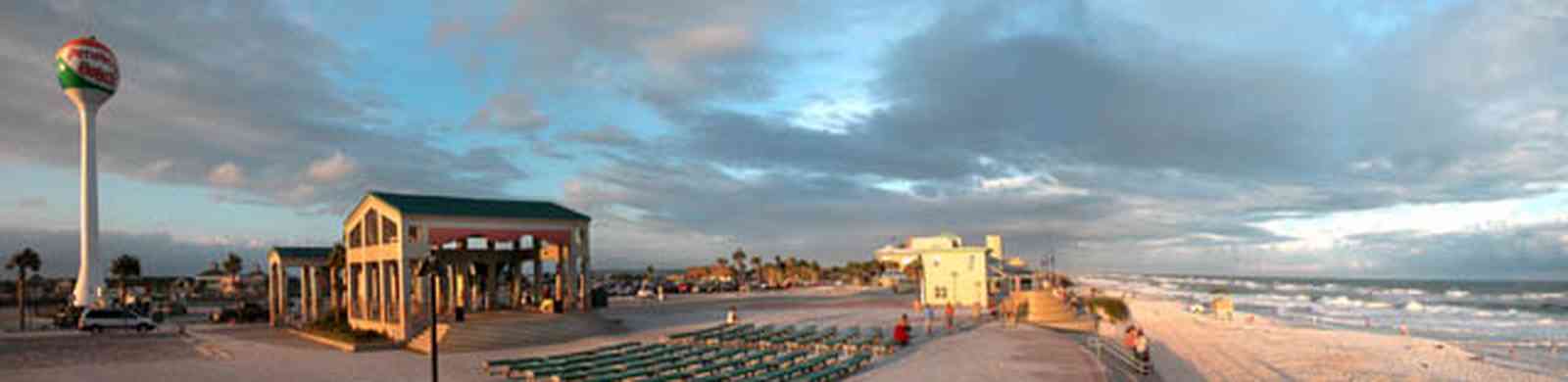 Pensacola-Beach:-Sunset_06.jpg:  pavillion, amphitheater, concert stage, benches, beach front, gulf of mexico, waves, surf, surfers, beach ball, water tower, parking lot, 