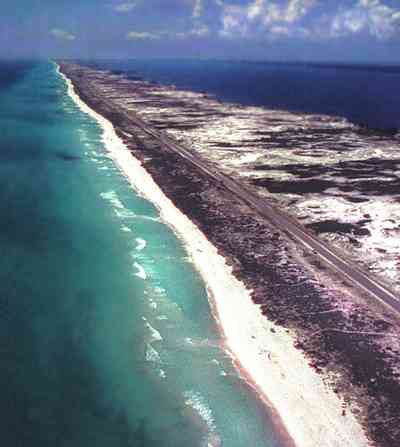 Pensacola-Beach:-Waterfront_10.jpg:  santa rosa island, gulf of mexico, seashore, dune, road, white sand, quartz sand crystal, wave, surf, barrier island, santa rosa sound, aerial view