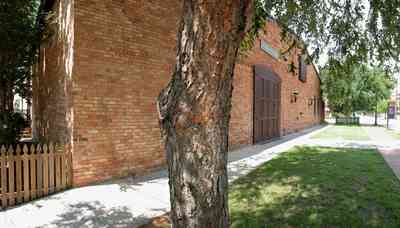 Pensacola:-Historic-Pensacola-Village:-Museum-Of-Commerce_03.jpg:  river birch tree, picket fence, museum, warehouse, historic district