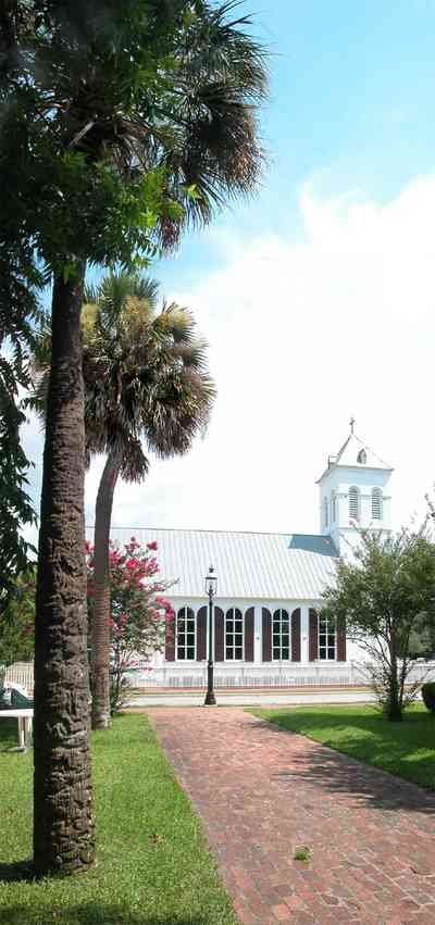 Pensacola:-Historic-Pensacola-Village:-Old-Christ-Church_06.jpg:  plaque, historic marker, brick structure, religious service, church house, crepe myrtle trees, palm trees, victorian village