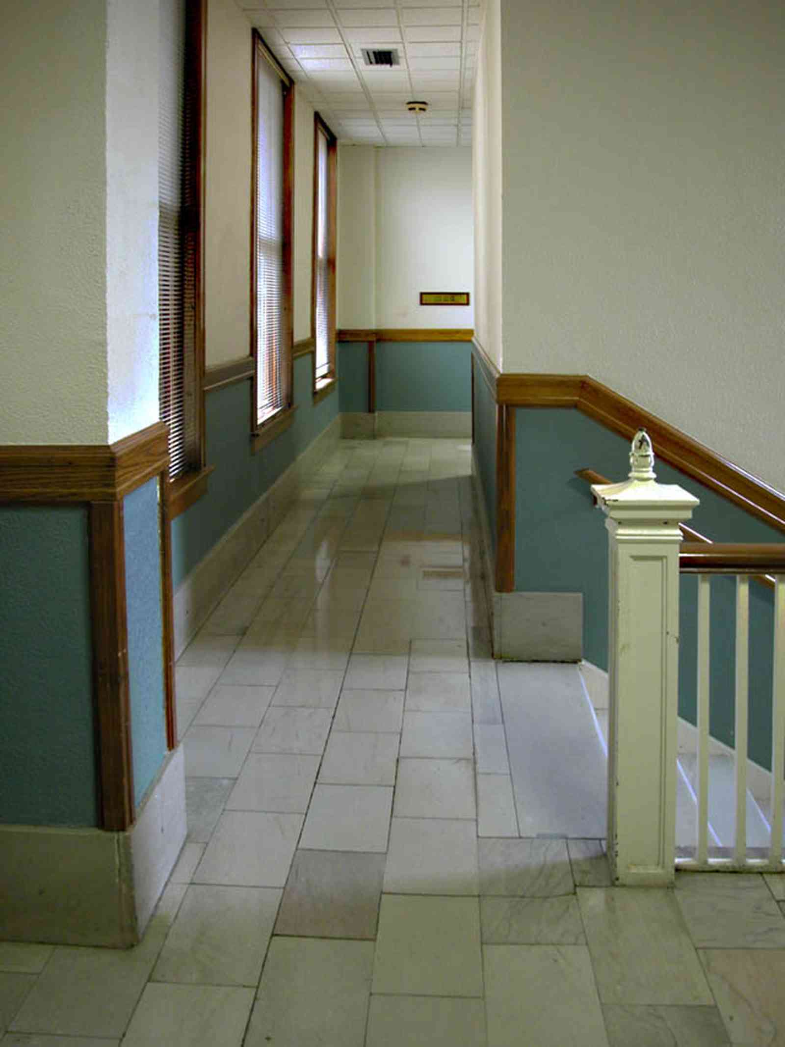Pensacola:-Palafox-Historic-District:-Blount-Building_07.jpg:  marble floor, casement window, stairwell, staircase, wainscotting
