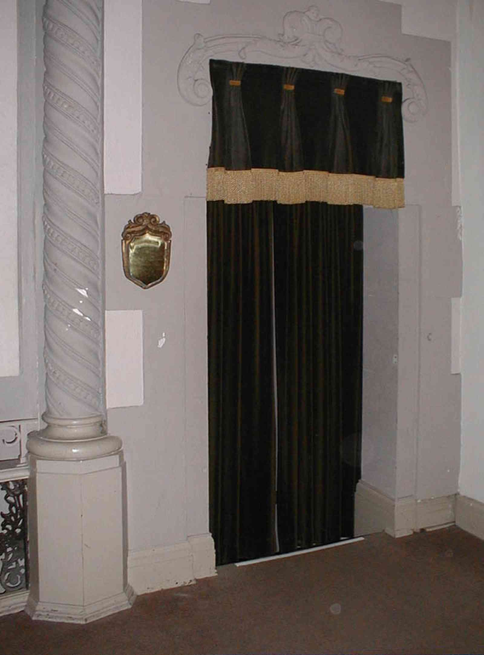 Pensacola:-Palafox-Historic-District:-Saenger-Theatre_09.jpg:  velvet curtain, column, plaque, fringe, spanish revival architecture