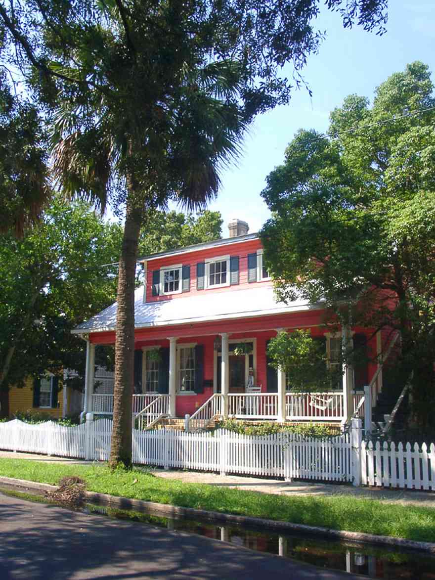 Pensacola:-Seville-Historic-District:-305-South-Adams-Street_00.jpg:  4-square georgian architectural style, victorian cottage, palm trees, picket fence, victorian porch, seville square