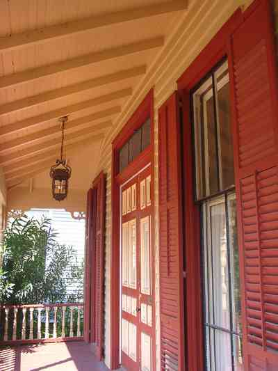Pensacola:-Seville-Historic-District:-412-East-Government-Street_04.jpg:  victorian house, victorian front porch, balustrade, lantern, shutters, gingerbread trim